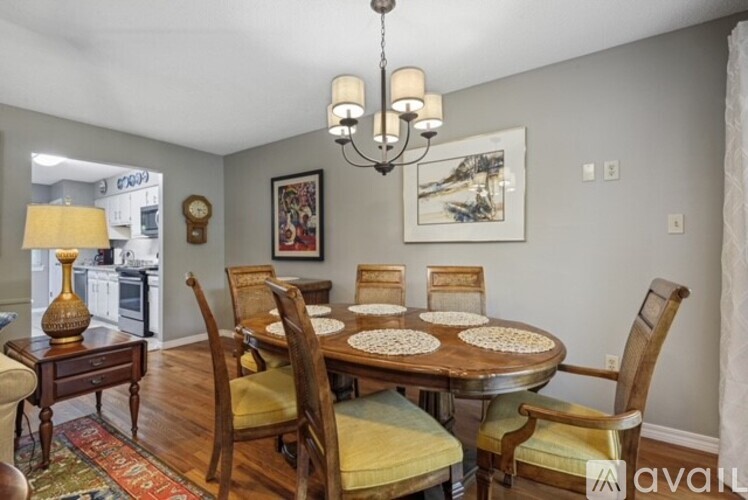 A dining room with a wooden table and chairs.
