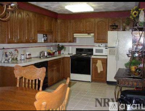 A kitchen with wooden cabinets and a white refrigerator.