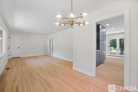 A room with wooden floors and a chandelier.