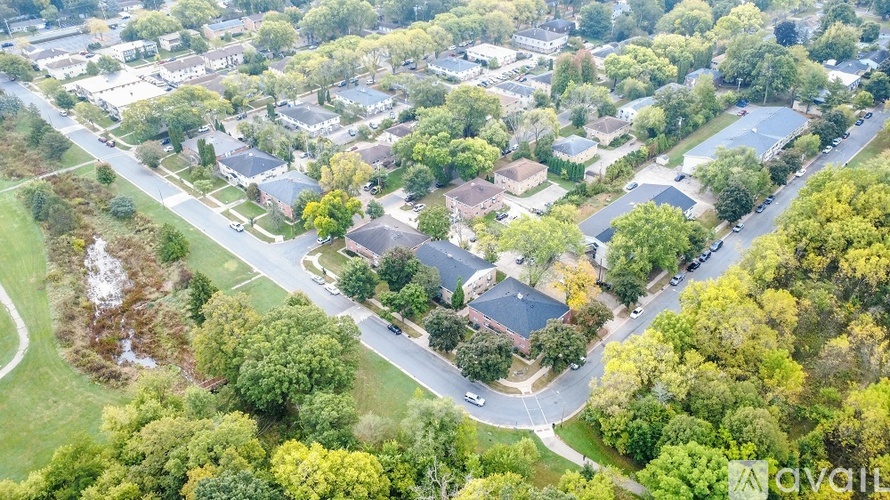 A bird's eye view of a residential area with houses and trees.