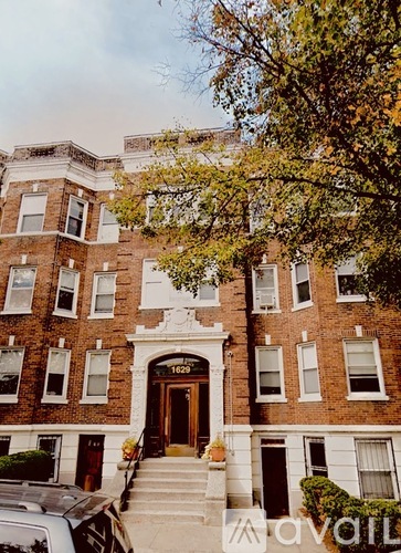 A brick building with the number 1022 on the front door.