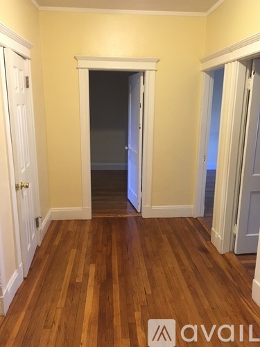 A room with wooden floors and white doors.