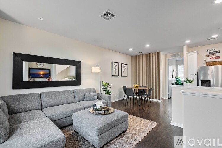 A living room with a grey sofa and a coffee table.