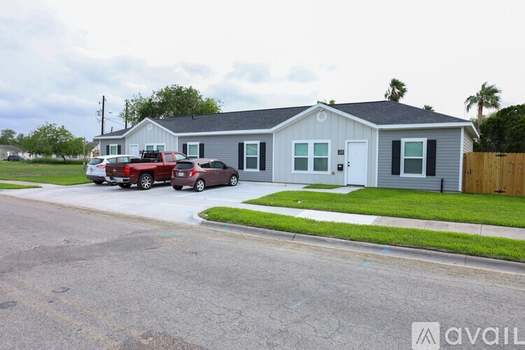 A house with a grey roof and a white garage door is shown.