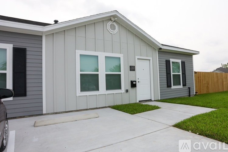 A grey house with a white door and windows.