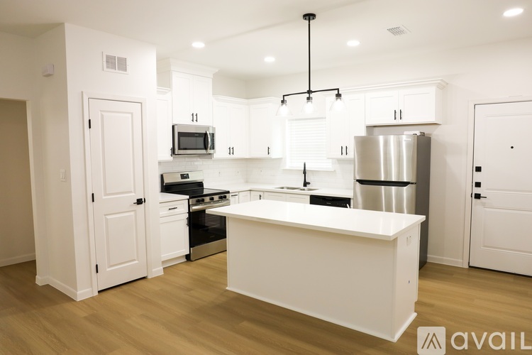 A modern kitchen with white cabinets and a central island.