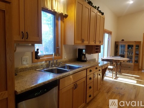 A kitchen with wooden cabinets and a granite countertop.