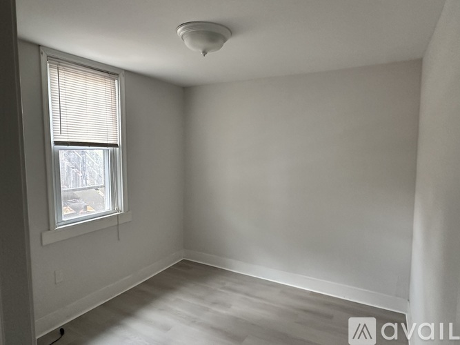 A room with a window and a ceiling light.