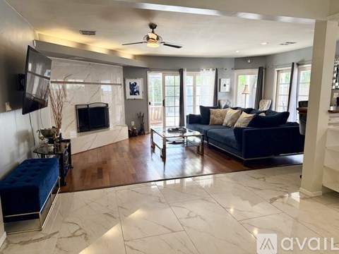 A living room with a blue couch and a television.