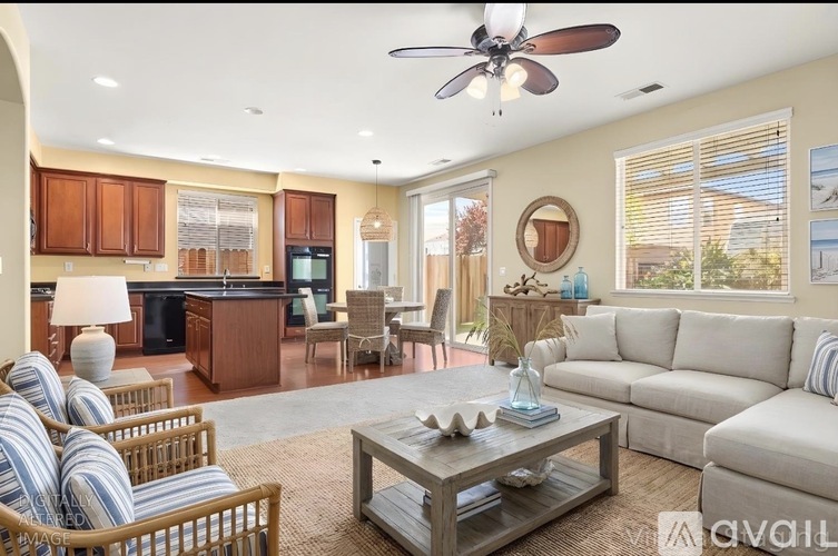 A living room with a sofa, chairs, and a coffee table.