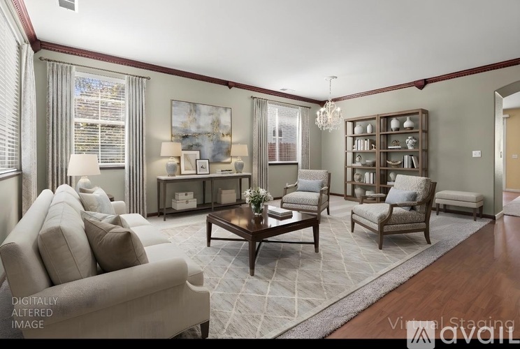 A living room with a large couch, a coffee table, and a bookshelf.