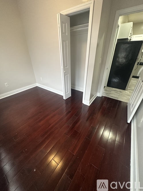 A room with wooden floors and white walls.