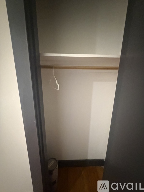 A white wall with a hanger on it.