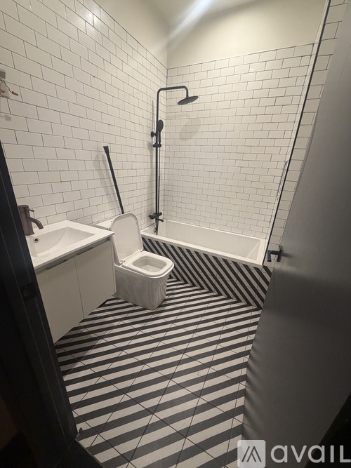 A bathroom with a black and white striped floor.