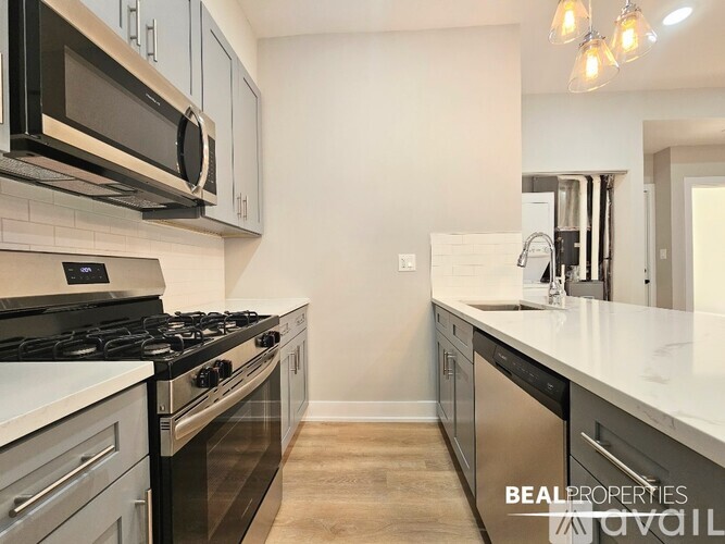 A kitchen with a stove top oven and microwave above it.