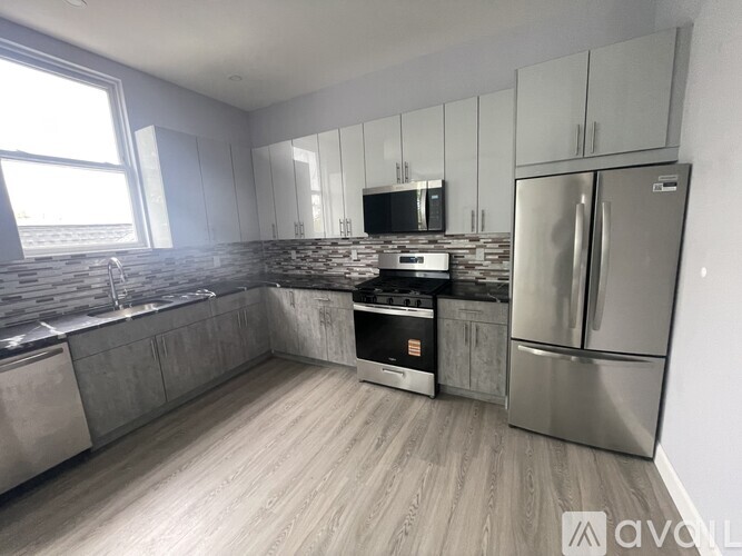 A kitchen with a stove, oven, and refrigerator.