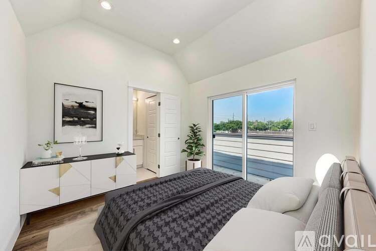 A bedroom with a large bed and a view of the outside.