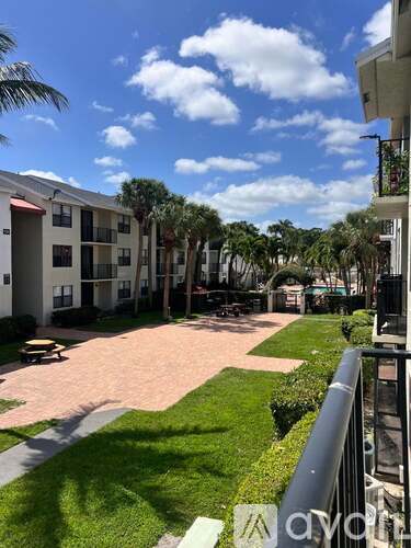A sunny day at the apartment complex with a clear blue sky.