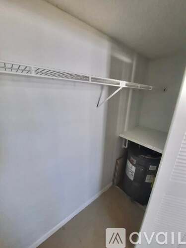 A white shelf is mounted on a white wall.