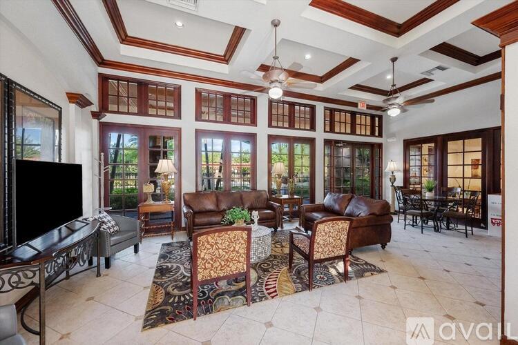 A living room with a fireplace and a large window.