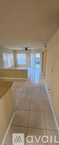 A room with a fan and a window.