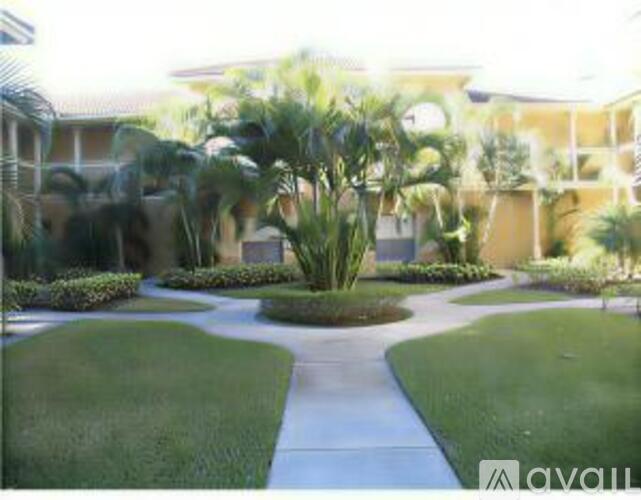 A well-manicured lawn and pathway in front of a building.