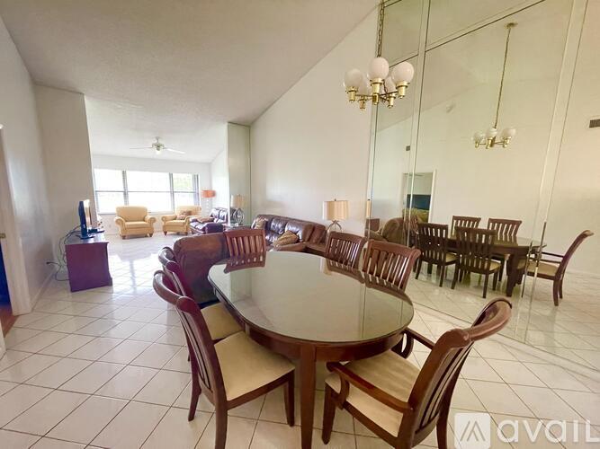 A dining room with a round table and chairs.