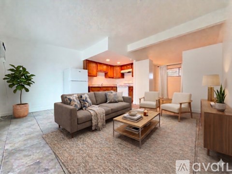 A living room with a grey couch and a wooden coffee table.
