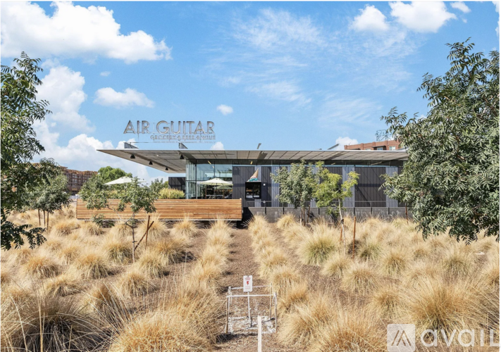 A modern building with the words "AIR GUITAR" on the roof.