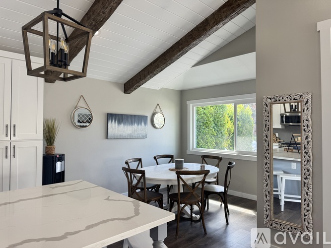 A dining room with a table set for four.