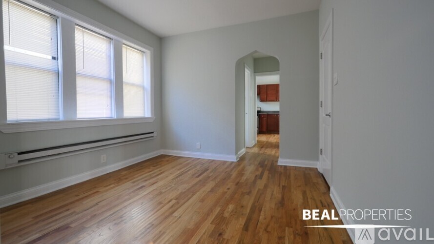 A room with wooden floors and a large window.
