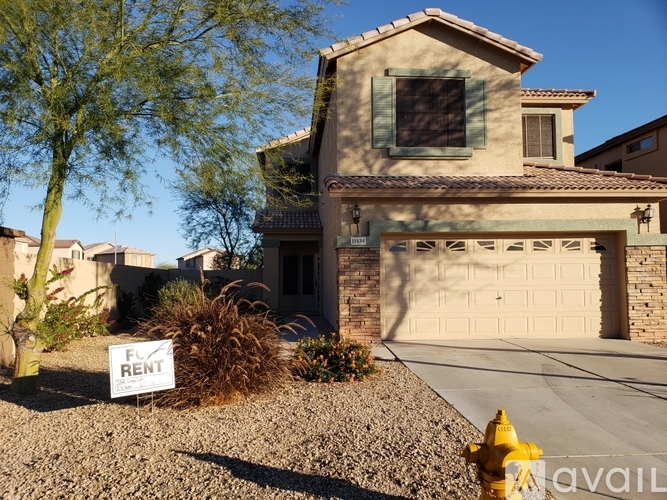 A house with a sign that says "For Rent" in front of it.
