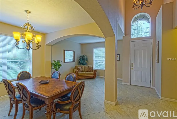 A dining room with a wooden table and chairs.