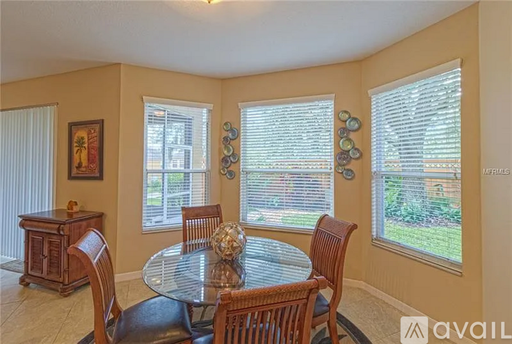 A dining room with a glass table and chairs.