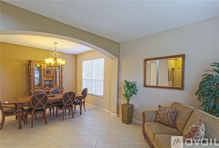 A dining room with a wooden table and chairs.