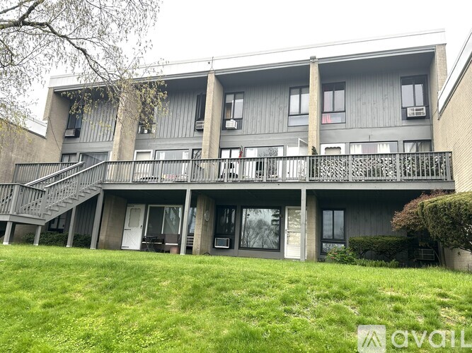 Apartment building with a green lawn in front.