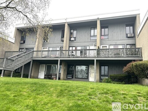 Apartment building with a green lawn in front.