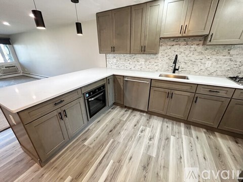 A kitchen with wooden floors and cabinets is available for rent.
