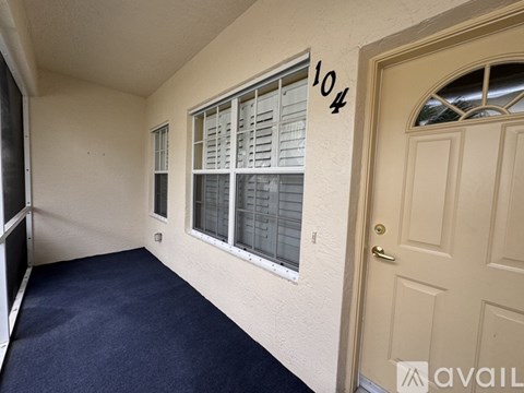 A room with a door and a window with shutters.