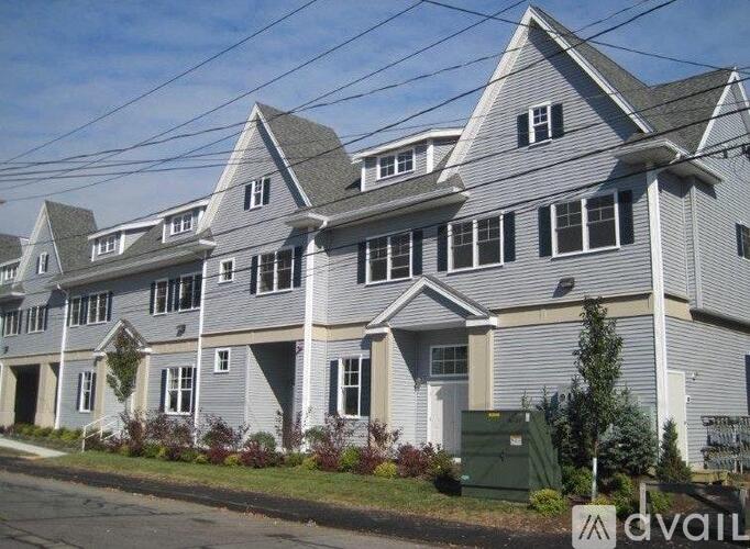 A row of houses with a sign that says "AVAIL" in front of them.