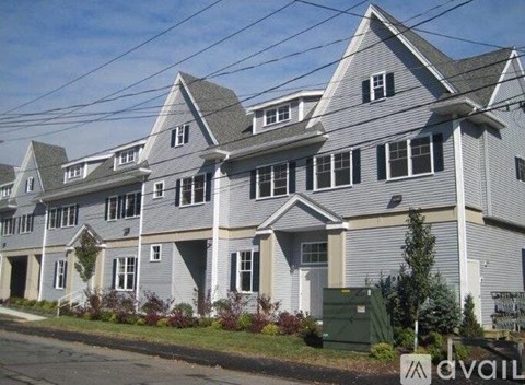 A row of houses with a sign that says "AVAIL" in front of them.
