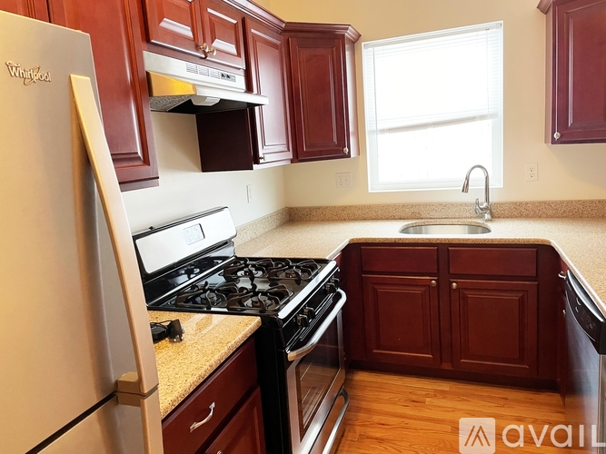 A kitchen with wooden cabinets and a white fridge.