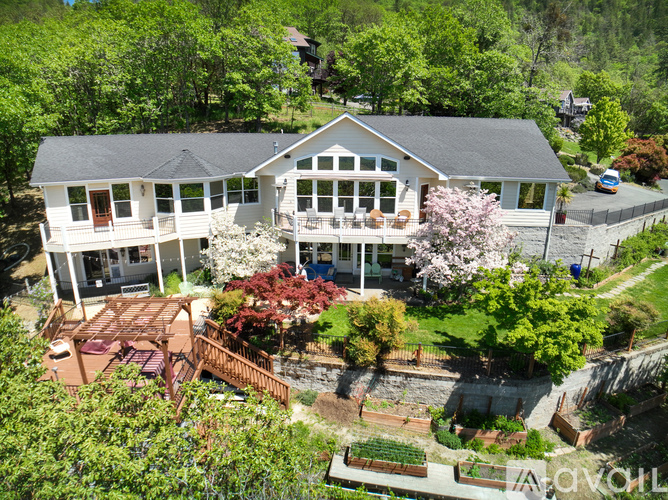 A house with a large front yard and a deck.