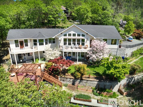 A house with a large front yard and a deck.