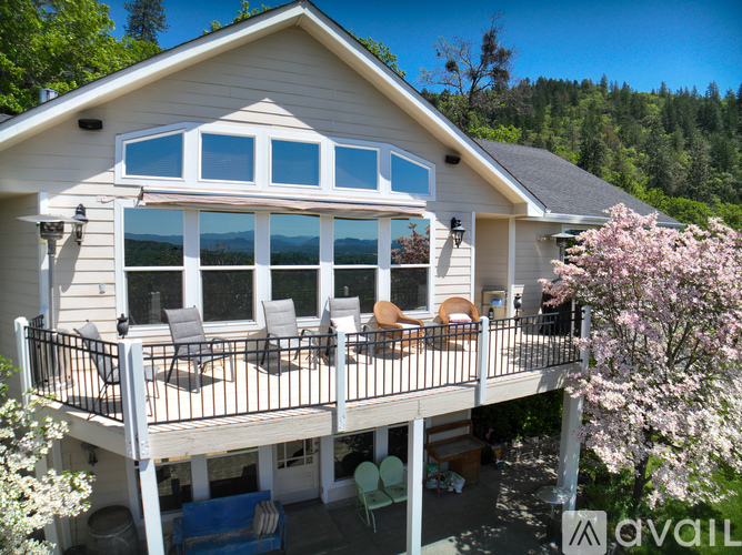 A house with a deck and patio furniture.