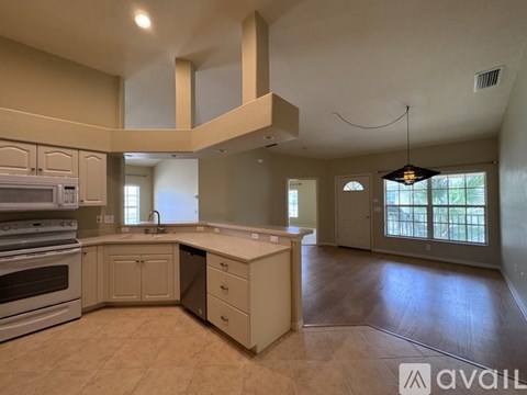 A spacious kitchen with a large island and a stove top oven.