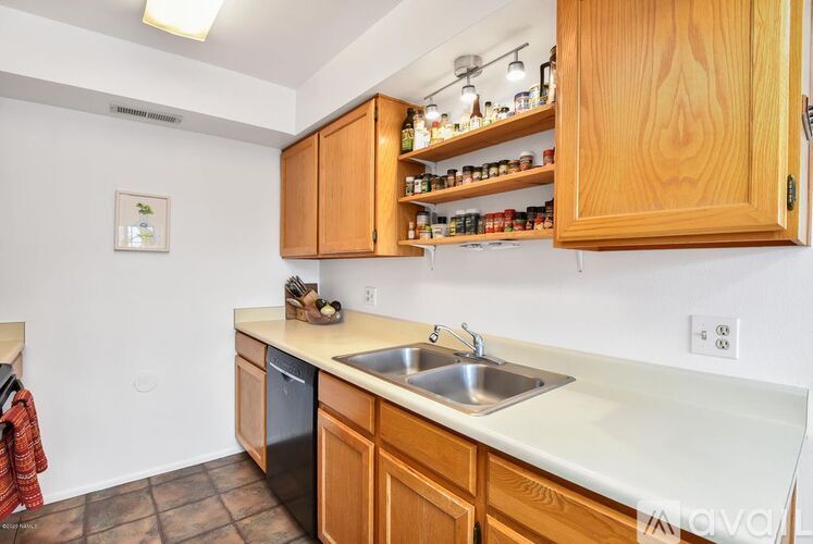 A kitchen with wooden cabinets and a white countertop.