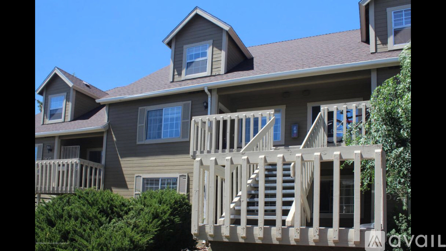 A house with a brown roof and a white deck.