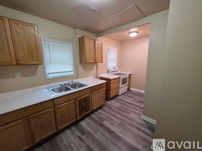 A kitchen with wooden cabinets and a white countertop.