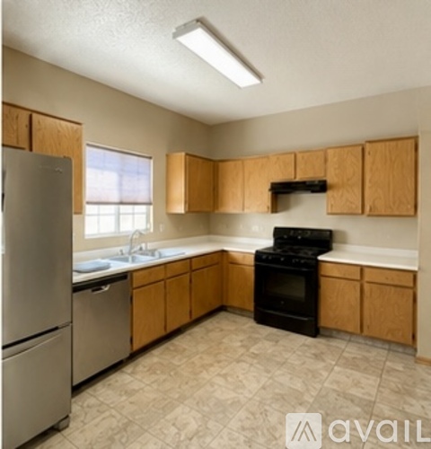 A kitchen with wooden cabinets and a black oven.